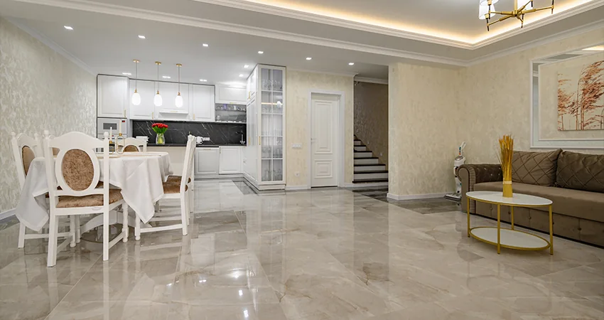 A large-format glossy floor through an open dining area