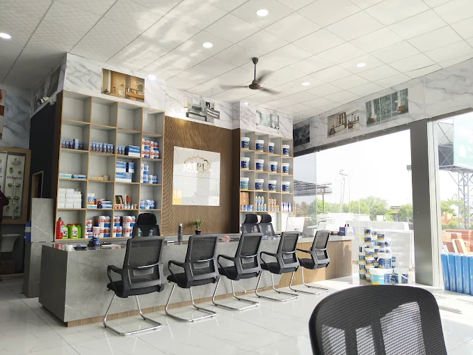 The sales counter, marble-clad wall and sanitaryware shelves inside the showroom